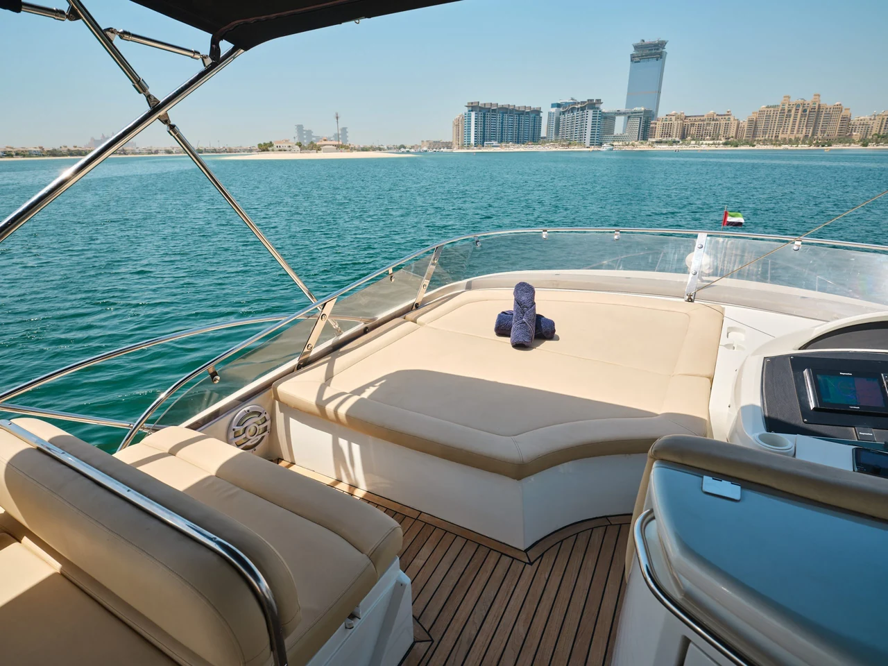 Cream flybridge sunpad and helm aboard Sunseeker Satoshi 70