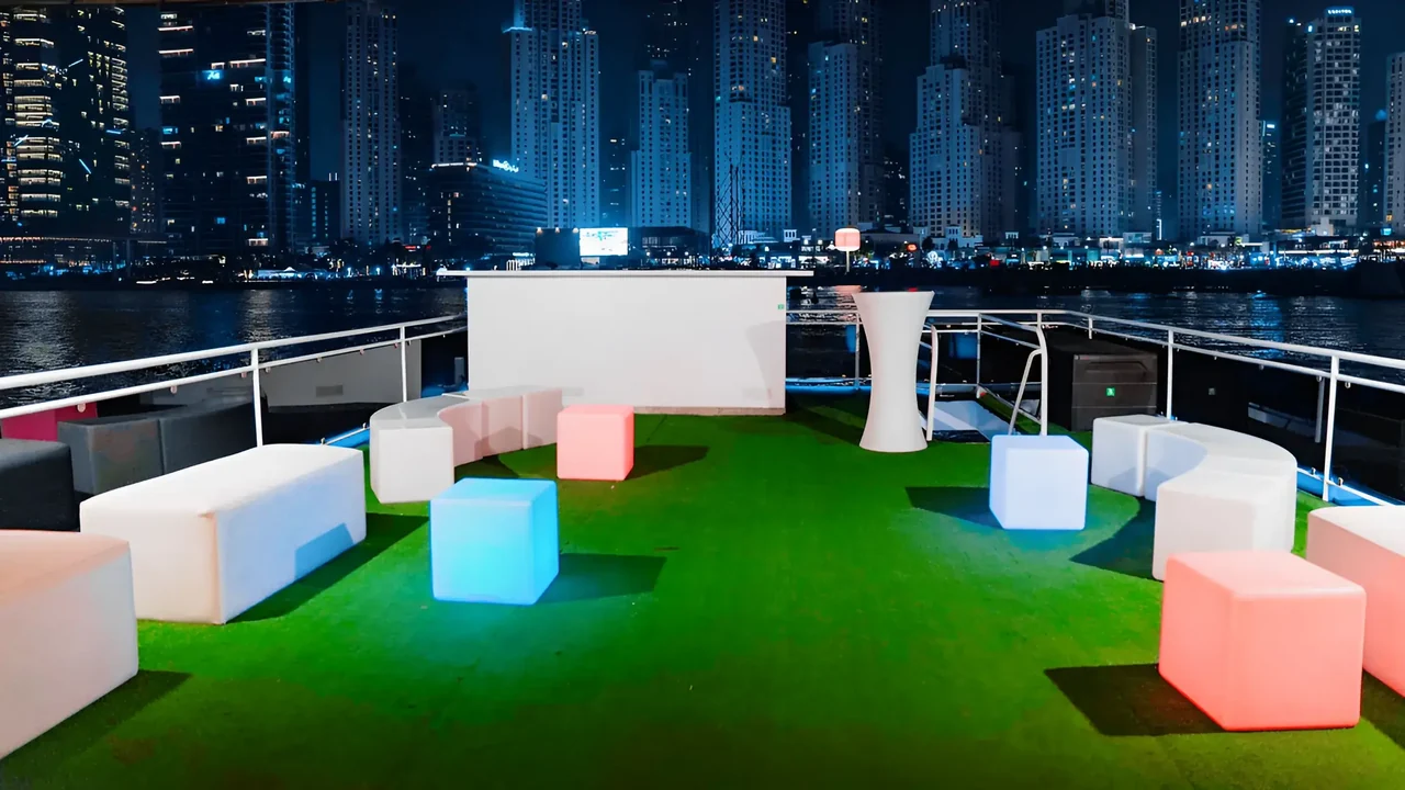 Illuminated upper deck lounge on Xclusive 8 at night