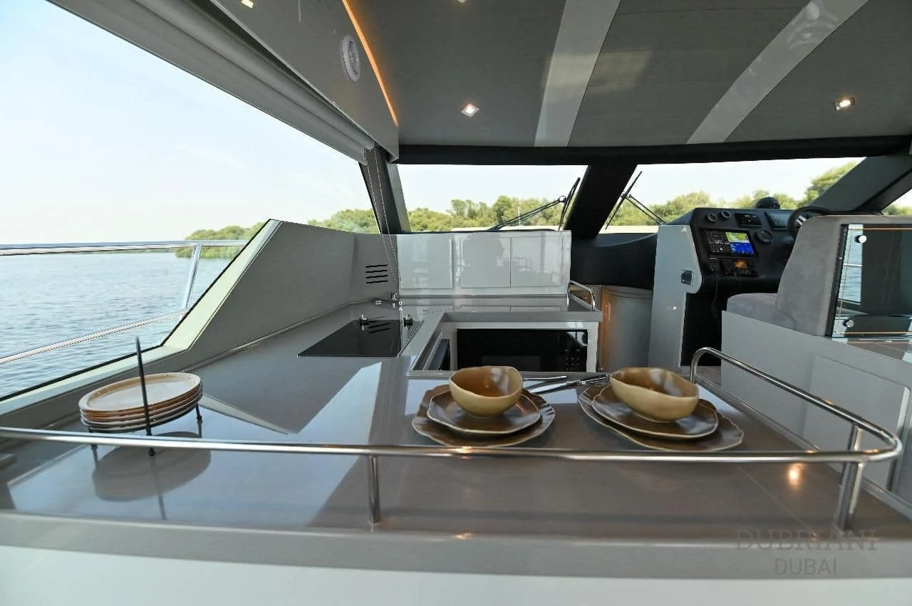Aft table with place settings and a sunpad on Novia 55