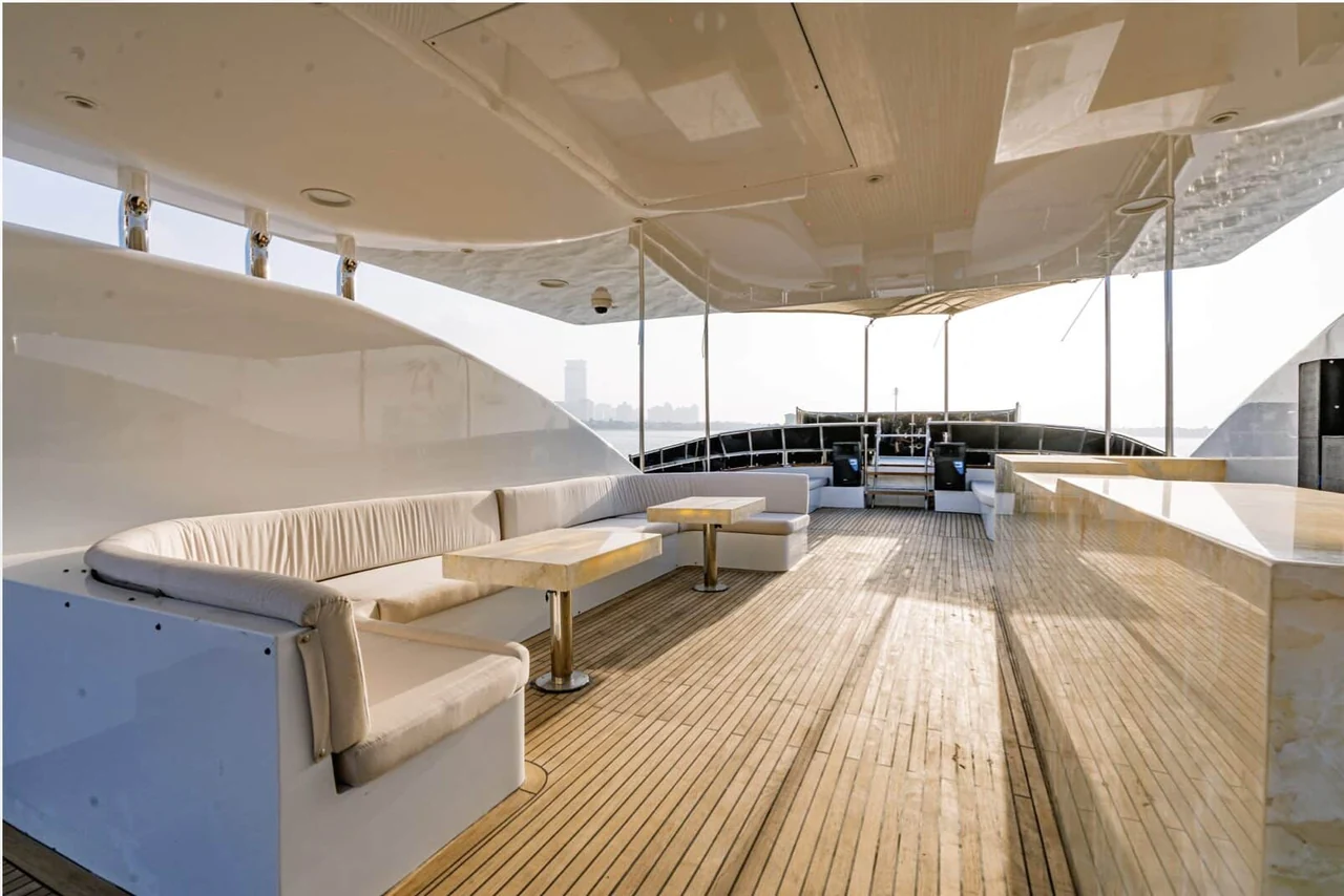 Covered teak deck with long lounge seats on Finesse