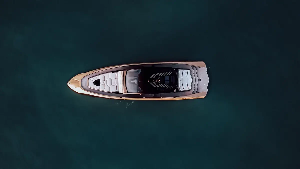 Overhead view of Lamborghini 63 Gold on dark blue water