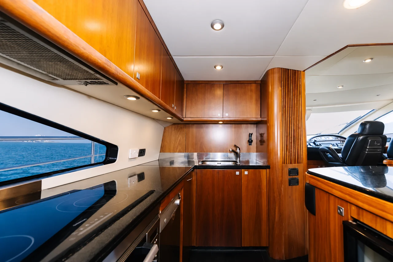 Wood-finished galley and helm area on Sunseeker 88