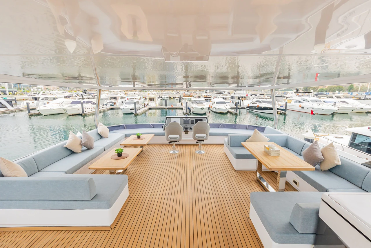 Covered lounge deck with sofas and low tables on Zirve 72