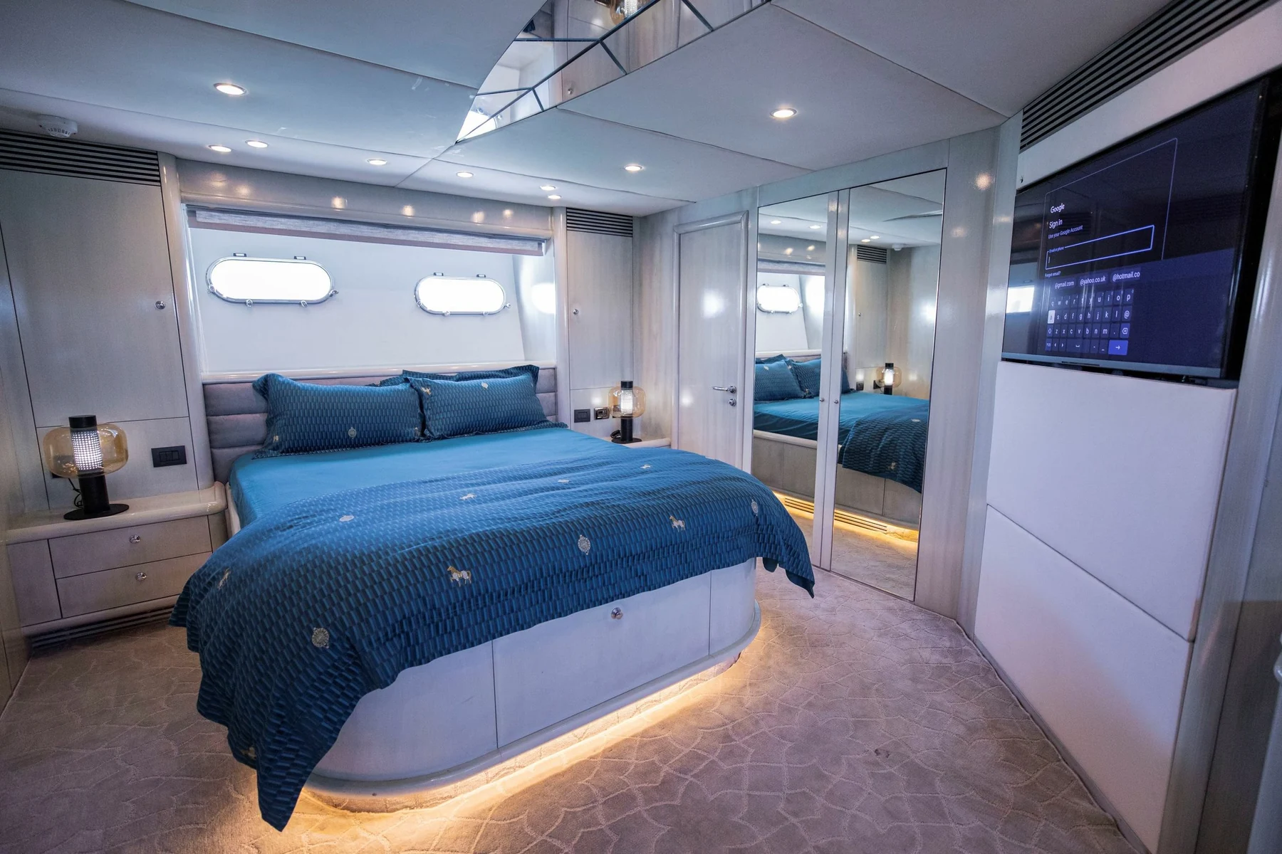 Black Predator 95 Sunseeker yacht master cabin with blue bedding